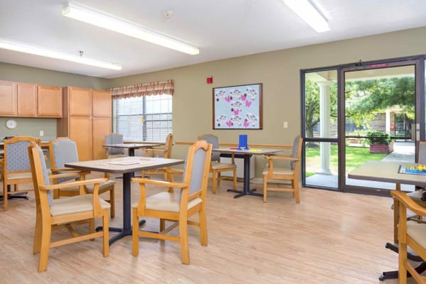 Bright activity room with tables and chairs