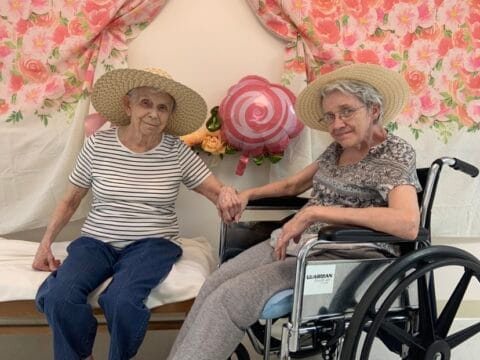 Two residents enjoying a decorated indoor space