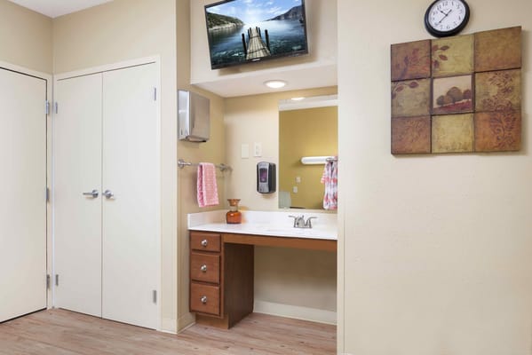 Interior of a resident room with a bathroom sink area
