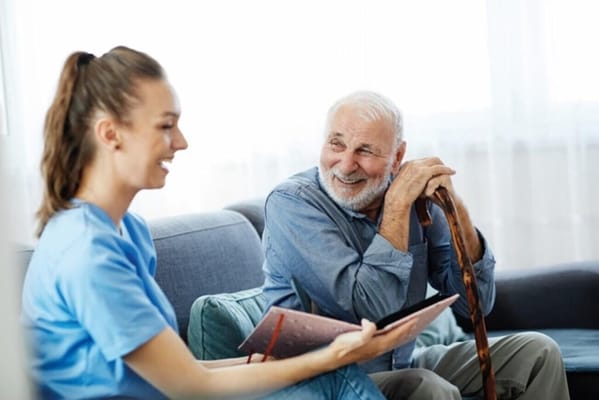 Senior resident interacting with caregiver in a cozy setting