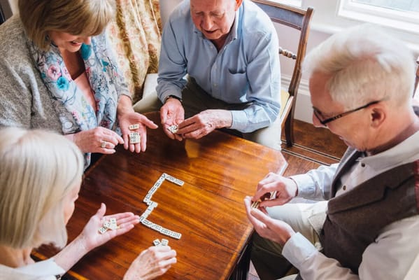 Residents playing a game together at a table