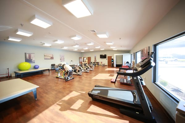 Bright and spacious fitness room with equipment