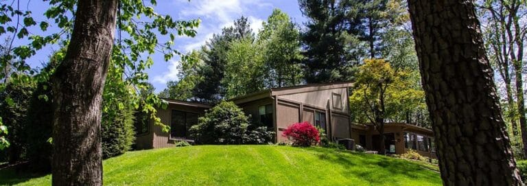 Exterior view of a nursing facility surrounded by trees