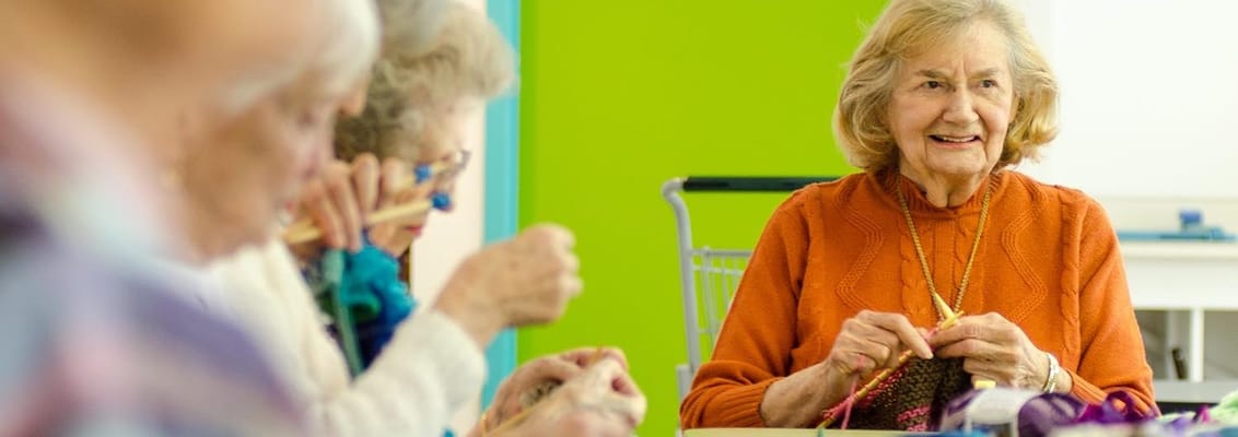 Group of seniors engaged in knitting activities