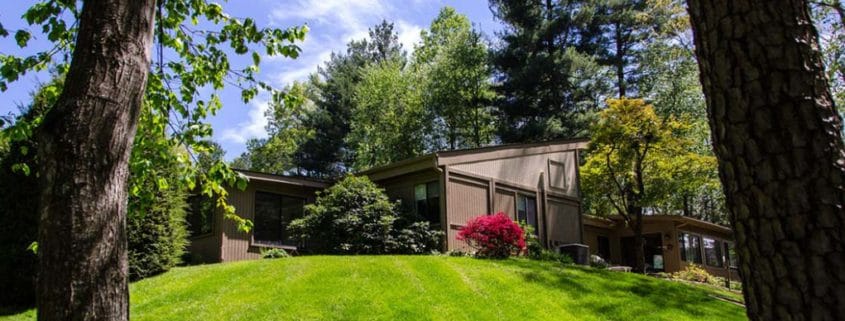 Exterior view of a senior living facility surrounded by greenery