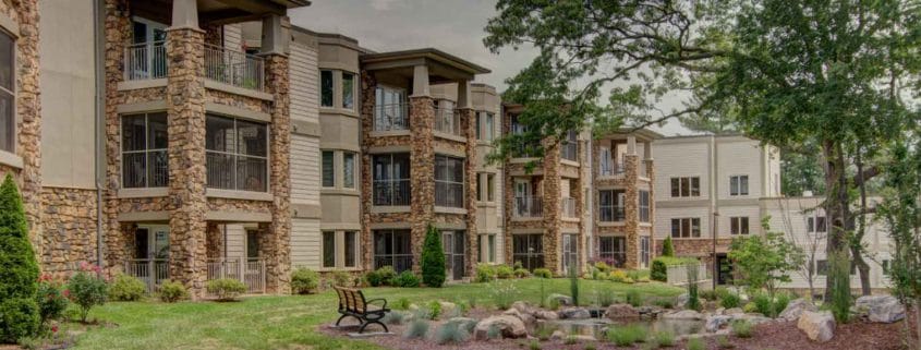 Exterior view of a senior living facility with landscaped gardens