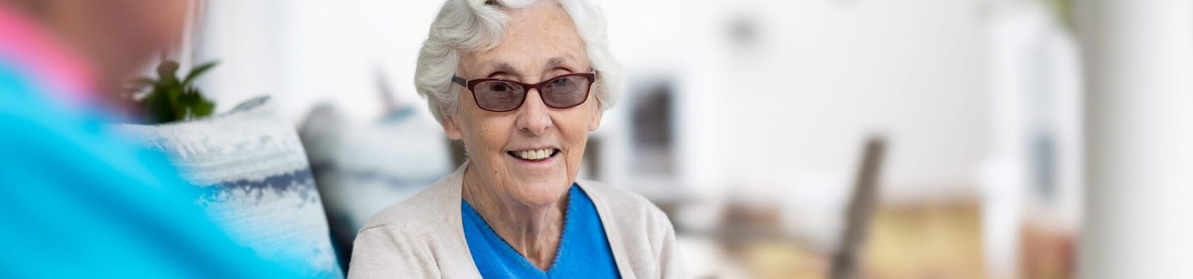 Senior woman smiling while seated indoors
