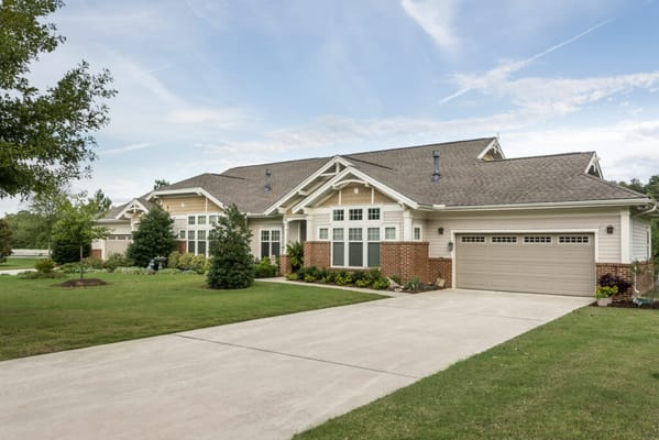 Exterior view of a senior living facility with gardens