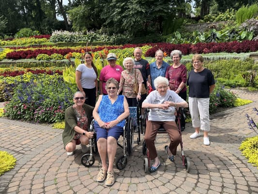 Residents and staff enjoying a colorful garden area