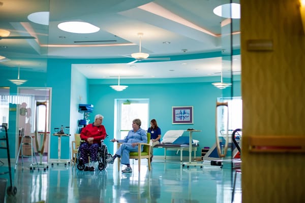 Two residents chatting in a bright communal area