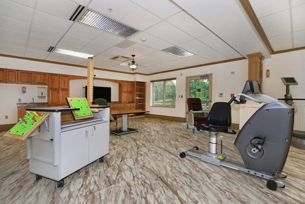 Physical therapy equipment in a spacious activity room