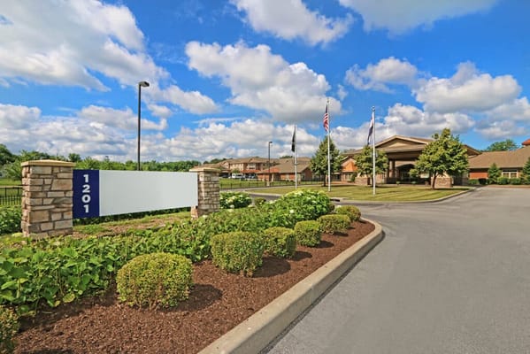 Front entrance of a senior living facility with landscaping