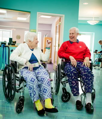 Two residents enjoying conversation in the activity room
