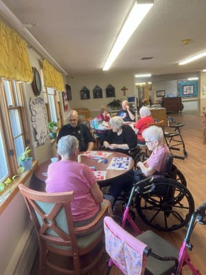 Residents participating in a game activity at a communal table