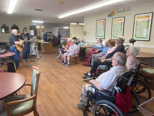 Residents enjoying a live music performance in a common area