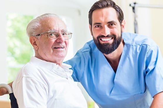 A caregiver smiling with a resident in a care facility