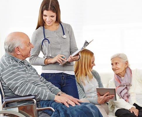 Residents engaging with staff in a bright common area