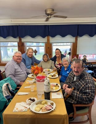 Residents enjoying a meal together at a dining table
