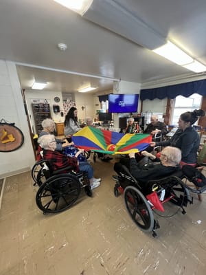 Residents participating in a colorful group activity indoors