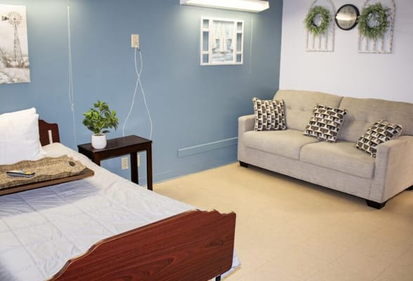 Cozy resident room with bed and seating area