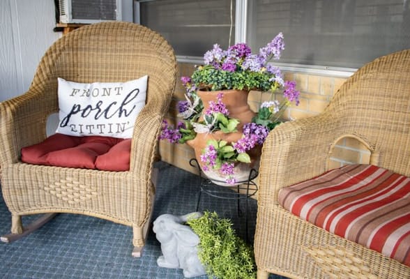 Cozy porch seating with flowers and decorations