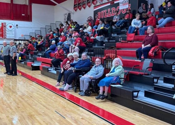 Residents watching a basketball game in a gym