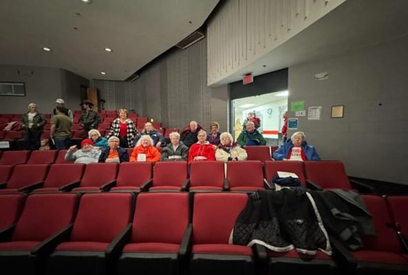 Residents gathered in a theater-style seating area
