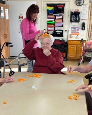 Residents engaging in an activity with a staff member
