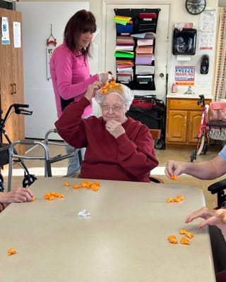 Residents engaging in an activity with a staff member
