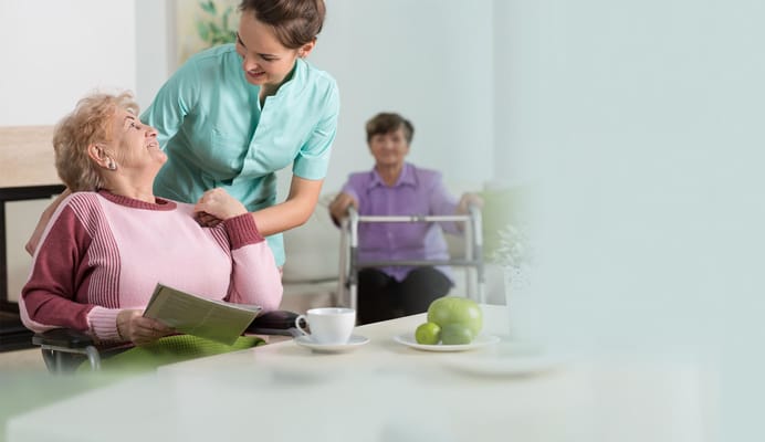 Staff assisting a resident in a common area