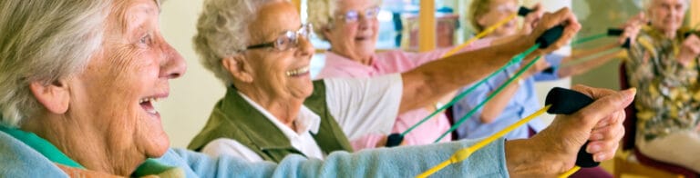 Seniors participating in a group exercise class with resistance bands