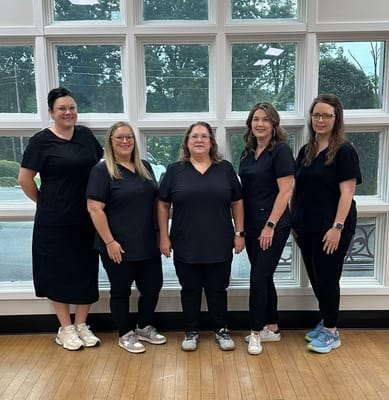 Staff members posing in a well-lit interior