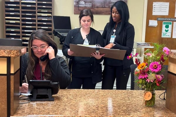 Staff assisting each other at the reception area