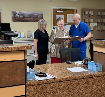 Staff and resident discussing in a bright office