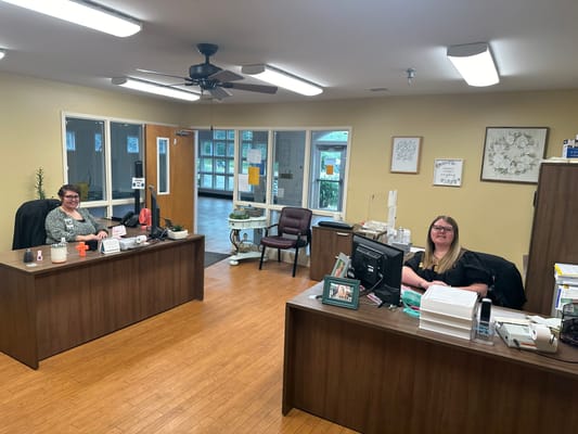 Reception area with two staff members at desks