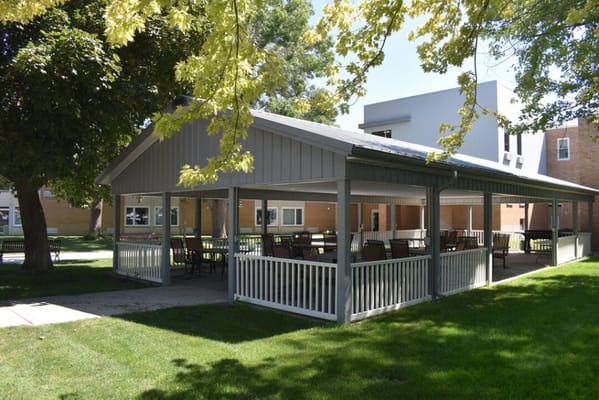 Covered outdoor seating area in a green space
