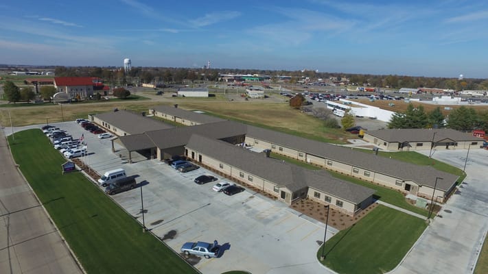 Aerial view of a senior living facility with parking lot