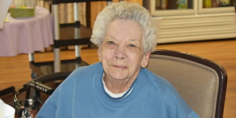 Elderly resident smiling in a common area