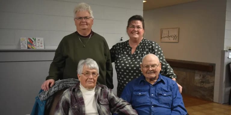 Staff and residents posing for a photo in the facility