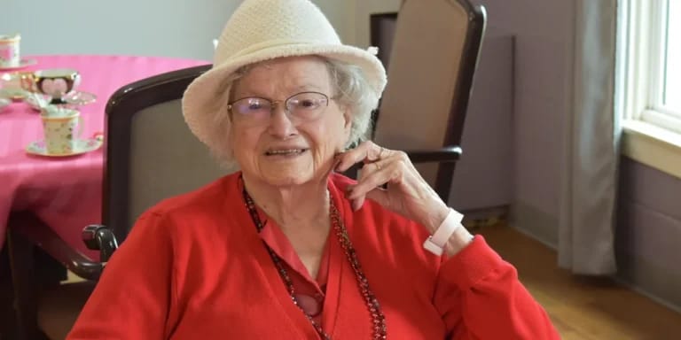 Resident enjoying tea in a bright common area