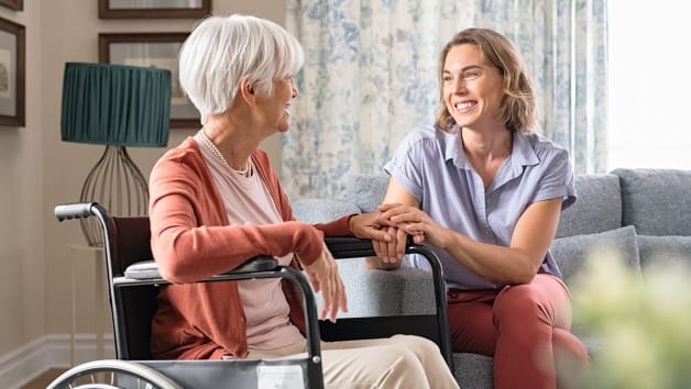 A caregiver interacting with a resident in a cozy living area