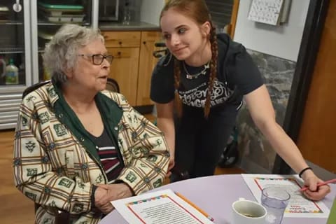 Staff member engaging with resident at a table