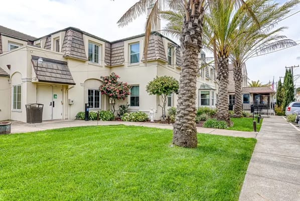 Exterior view of a senior living facility with landscaping