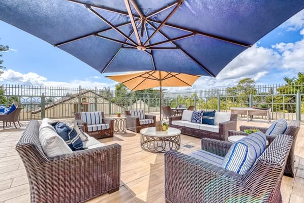 Well-furnished outdoor seating area with umbrellas