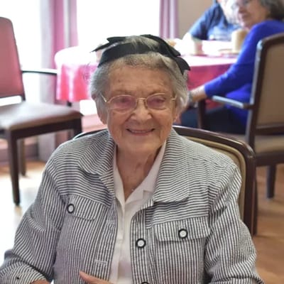Senior resident smiling in a common area