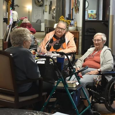 Three residents engaged in an activity in a common area