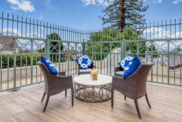Outdoor seating area with chairs and plants