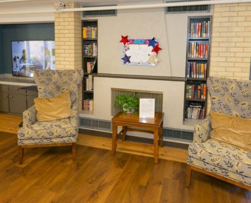 Cozy common area with bookshelves and chairs