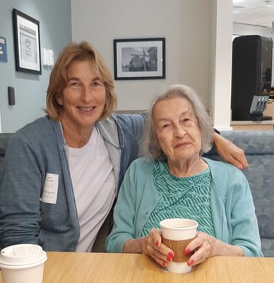 Two women sharing a moment in a common area