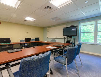A bright conference room with tables and chairs